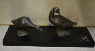 After Irene Rochard  , an Art Deco patinated spelter group of two ducks and a snail, on a