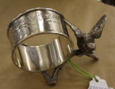A silver napkin ring holder by Hilliard  &  Thomason,   decorated with a bird on a branch,