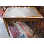 A mahogany office writing table   with faux leather surface.