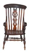 A Victorian fruitwood and elm Windsor armchair  , mid 19th century, the bar back above central