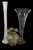 A glass vase, of drawn trumpet form, 49cm high; a tall slender opaque-white...   A glass vase,