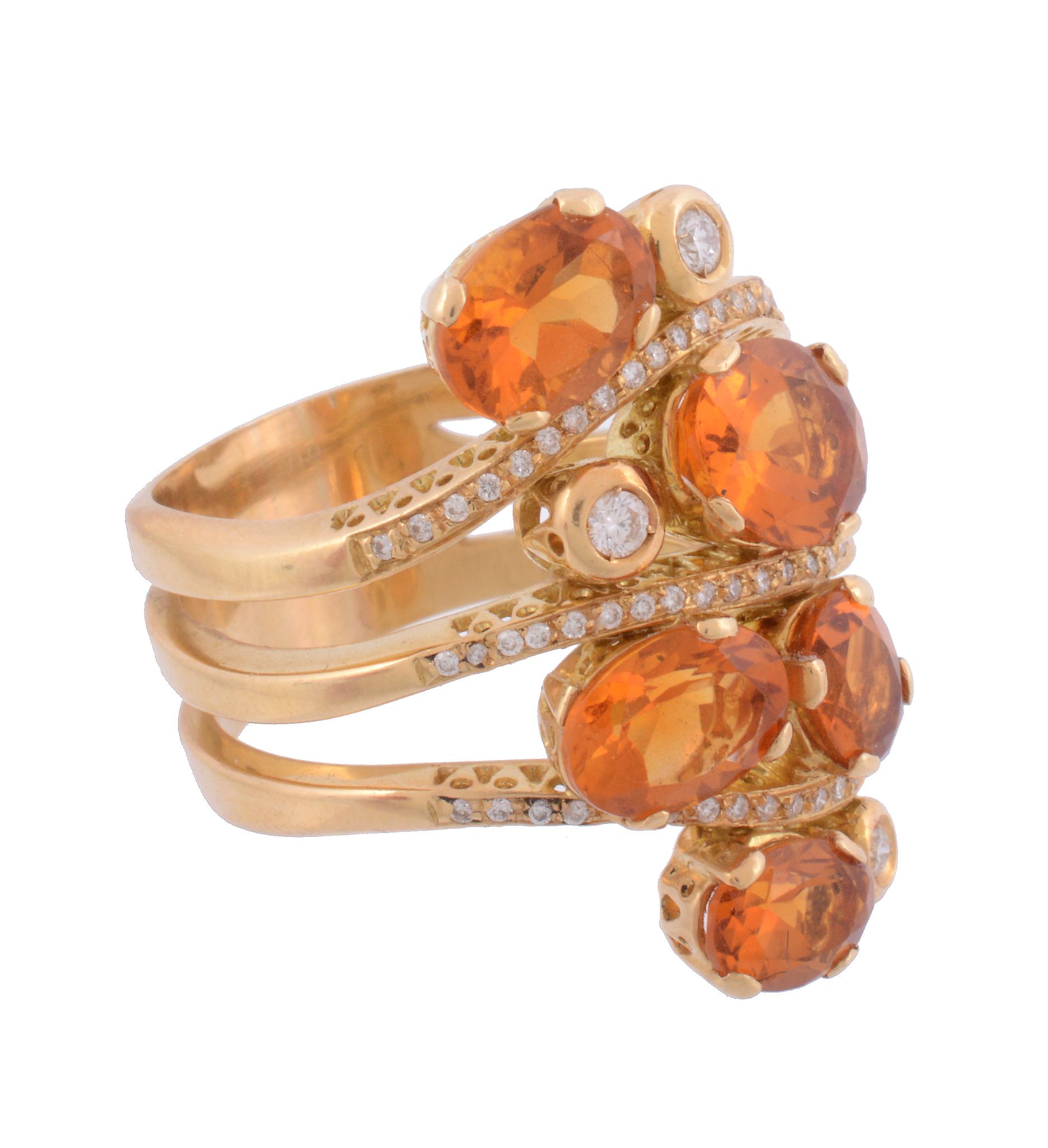 A citrine and diamond ring,   the oval shaped citrines set on an openwork shank accented with