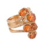 A citrine and diamond ring,   the oval shaped citrines set on an openwork shank accented with