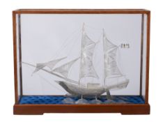 A silver coloured model of a twin masted sailing ship,   stamped   900   only, probably Asian,