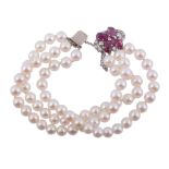 A cultured pearl bracelet with a diamond and ruby clasp  , the three rows of uniform cultured