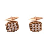 A pair of diamond set cufflinks  , the tonneau shaped panels each set with nine brilliant cut