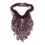 A garnet torsade necklace,   the multi strand necklace composed of vari cut polished garnet beads