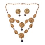 A gold and sapphire necklace,   composed of two rows of circular and pear shaped disks each with