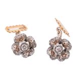 A pair of diamond flower head cufflinks  , the pierced two colour flower heads with a central