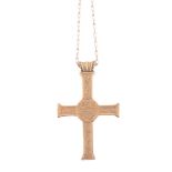 A cross pendant,   circa 1993, engraved with the Lamb of God between  the Greek letters Alpha and