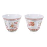 A pair of Chinese Famille Rose tea bowls, painted with Buddhistic symbols...   A pair of Chinese
