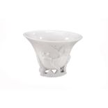 A Dehua Libation cup, Qing Dynasty, of deep oval U-shape   A Dehua Libation cup, Qing Dynasty,