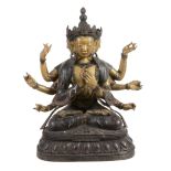 A Sino-Tibetan bronze seated multi-headed figure   A Sino-Tibetan bronze seated multi-headed figure,