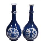A pair of Chinese blue and white powder-blue ground bottle vases, Kangxi   A pair of Chinese blue
