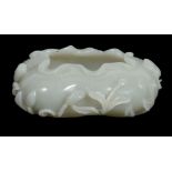 A Chinese celadon jade brush washer, of even colour with one area with...   A Chinese celadon jade
