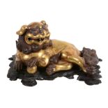 A gilt-metal Buddhistic lion censor and cover, recumbent with one paw on a ball   A gilt-metal