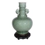 A Chinese celadon two-handled vase , the ovoid body with foliage and mask...   A Chinese celadon