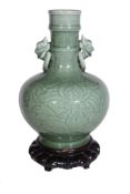 A Chinese celadon two-handled vase , the ovoid body with foliage and mask...   A Chinese celadon