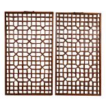 A pair of Chinese hardwood lattice window panels, with metal handles to the top   A pair of