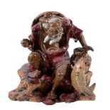 A Chinese stoneware figure of a fisherman, glazed in red and brown, 23.5cm high   A Chinese
