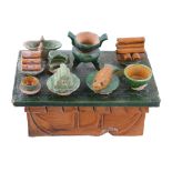 A Chinese sancai glazed pottery model of an altar table and offerings   A Chinese sancai glazed