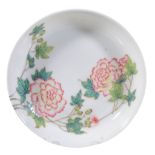 A Chinese Famille Rose saucer dish, painted with peony and green foliage   A Chinese  Famille Rose