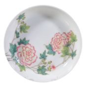 A Chinese Famille Rose saucer dish, painted with peony and green foliage   A Chinese  Famille Rose