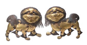 A pair of gilt copper repoussé Buddhistic lion panels, possibly Tibetan   A pair of gilt copper