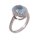 An aquamarine and diamond ring, the central oval cut aquamarine in a four...   An aquamarine and