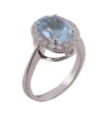 An aquamarine and diamond ring, the central oval cut aquamarine in a four...   An aquamarine and