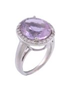 A diamond and amethyst cluster ring , the oval cut amethyst within a...   A diamond and amethyst