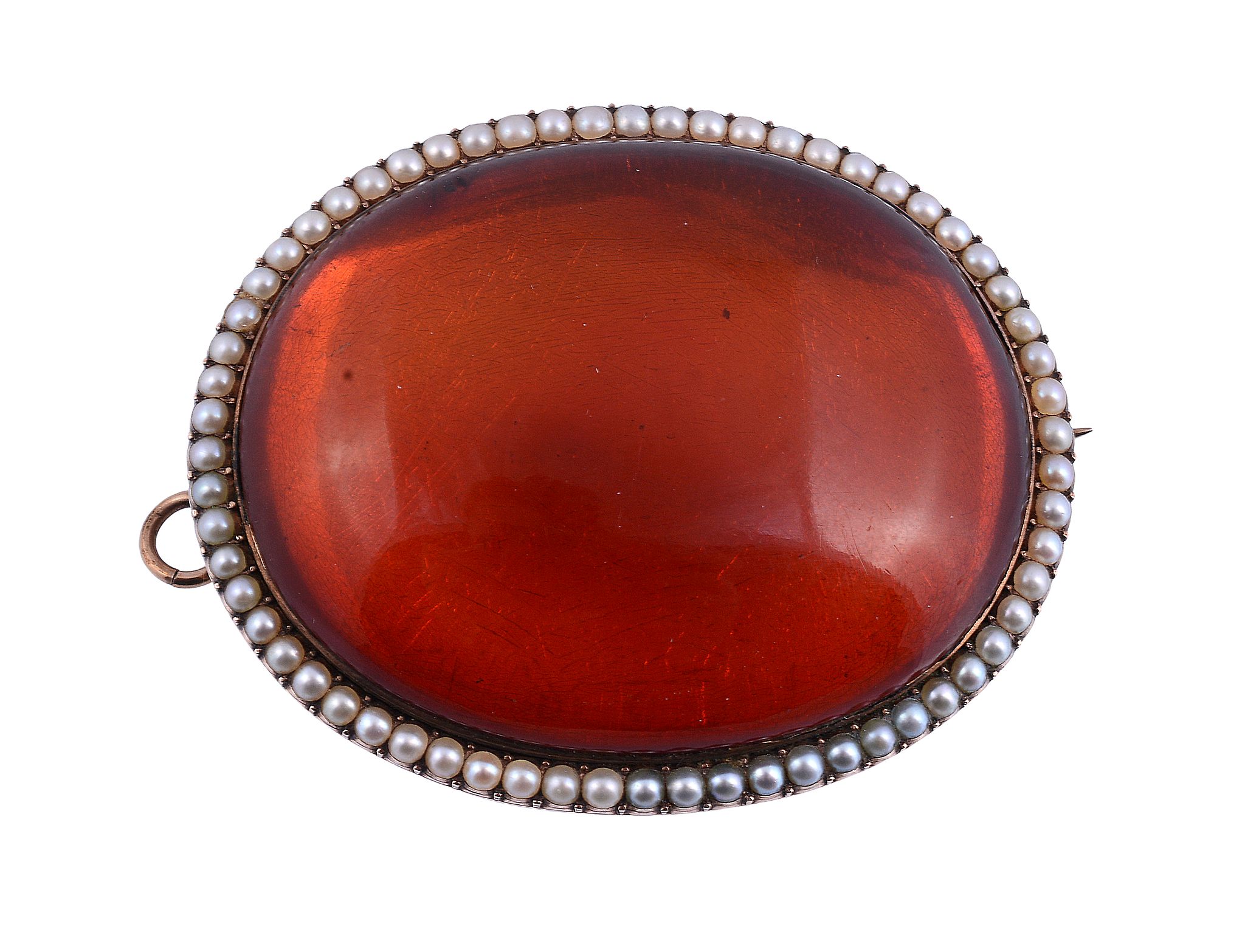 An amber and half pearl brooch, the oval cabochon amber within a border of...   An amber and half
