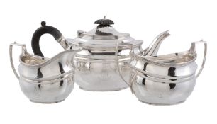 A silver oval three piece tea service by Harrods Ltd   A silver oval three piece tea service by