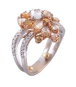 A diamond and coloured diamond ring, the oval cut diamond claw set within a...   A diamond and