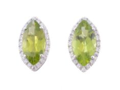 A pair of peridot and diamond earrings, the marquise cut peridot claw set...   A pair of peridot and