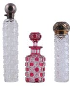 Three cut glass scent or dressing table bottles, all late 19th century   Three cut glass scent or