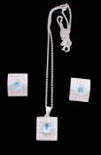 A blue topaz and diamond pendant, the central oval cut blue topaz within a...   A blue topaz and
