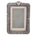 An Edwardian silver mounted small photograph frame by E   An Edwardian silver mounted small