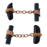 A pair of hardstone cufflinks, each cufflink with a shaped polished onyx...   A pair of hardstone