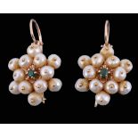 A pair of cultured pearl earrings, the cluster of cultured pearls centrally...   A pair of