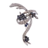 An 18 carat gold sapphire and diamond scrolled brooch , circa 1970   An 18 carat gold sapphire and