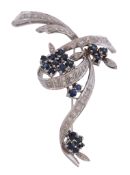 An 18 carat gold sapphire and diamond scrolled brooch , circa 1970   An 18 carat gold sapphire and