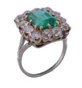 An emerald and diamond ring, the central rectangular cut emerald   An emerald and diamond ring,