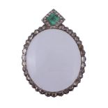 An emerald and diamond locket, the oval shaped locket with a border of vari...   An emerald and