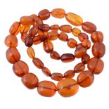 An amber bead necklace, the forty five graduated polished beads measuring...   An amber bead