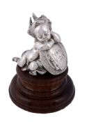 A Victorian silver model of a sleeping cherub, duty and standard marks only   A Victorian silver
