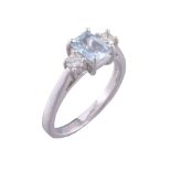 An 18 carat gold diamond and aquamarine three stone ring   An 18 carat gold diamond and aquamarine