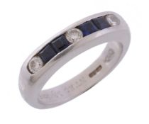 A platinum sapphire and diamond ring, channel set with calibre cut sapphires...   A platinum