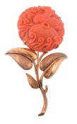 A coral brooch, circa 1960, the circular shaped coral carved with a duck   A coral brooch,   circa