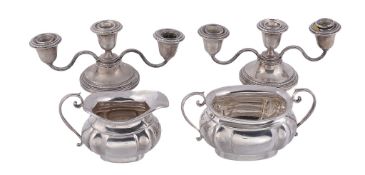 A silver shaped oblong baluster cream jug and sugar basin by Joseph Gloster Ltd   A silver shaped